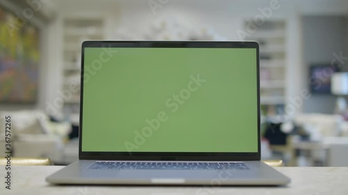 Home office. Green screen laptop computer sitting on a kitchen island. Footage shot with RED, available in 4K and HD. Download the preview for free.
