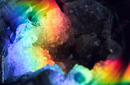 Iridescent natural transparent glossy geode and magic geometric Agate crystal stucture through sun light.