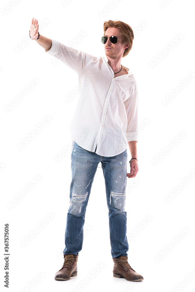 Young stylish man with sunglasses shading and blocking harsh sunlight with hand. Full body length isolated on white background. Young stylish man with sunglasses shading and blocking harsh sunlight with hand. Full body length isolated on white background.