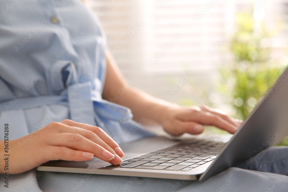 Woman working with modern laptop indoors, closeup Woman working with modern laptop indoors, closeup