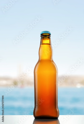 Bottle of beer on the background of the sea