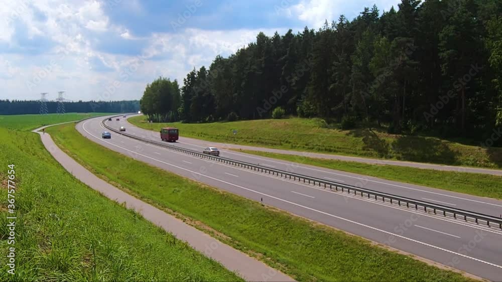 Cars driving on an asphalt road on a highway in summer 27 July 2020 Minsk Belarus Cars driving on an asphalt road on a highway in summer 27 July 2020 Minsk Belarus