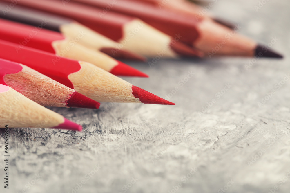 Colored pencils on grey wooden table Colored pencils on grey wooden table