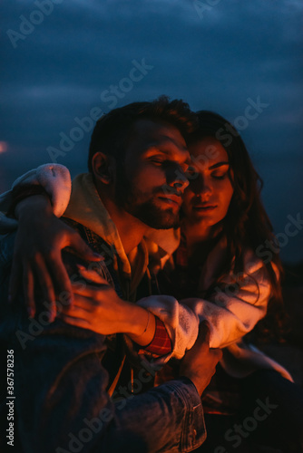 attractive woman hugging handsome man at night