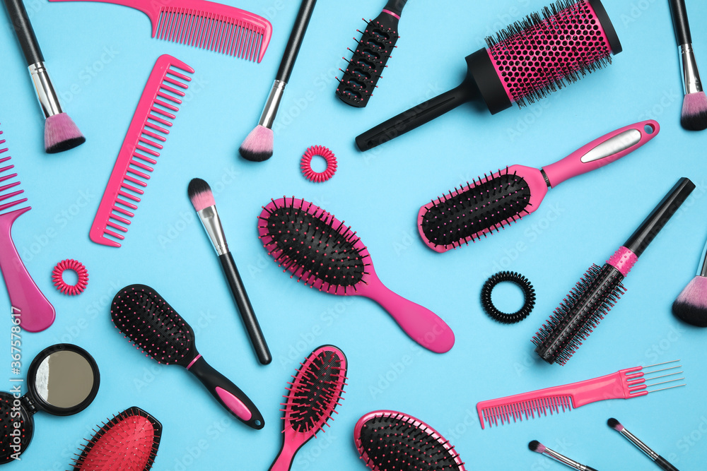 Flat lay composition with modern hair combs and brushes on light background Flat lay composition with modern hair combs and brushes on light background