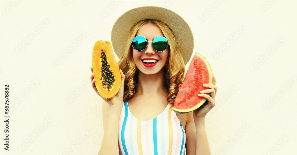 Summer portrait of happy smiling woman with fruits slice of watermelon and papaya wearing straw hat, sunglasses on white background Summer portrait of happy smiling woman with fruits slice of watermelon and papaya wearing straw hat, sunglasses on white background