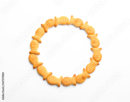 Delicious crispy goldfish crackers on white background, top view