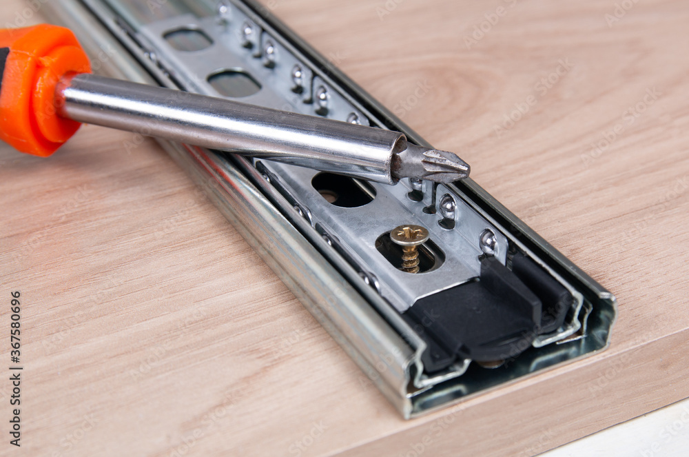 Metal sliding strips for furniture drawers and screwdriver
