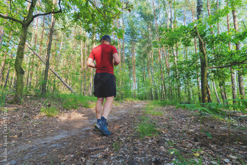 Athlete running on rough terrain in the woods, trail running Athlete running on rough terrain in the woods, trail running