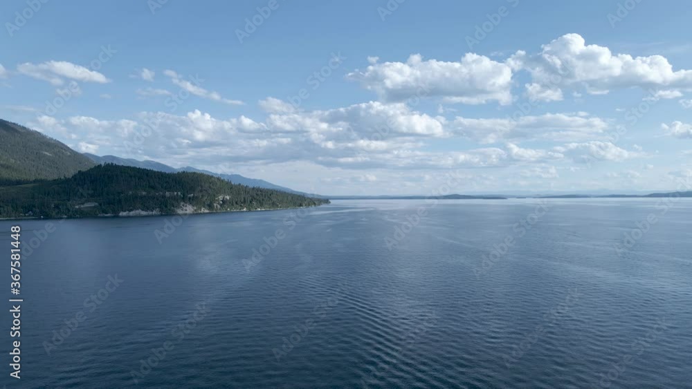 Drone rising above calm waters of Flathead lake, Montana Drone rising above calm waters of Flathead lake, Montana