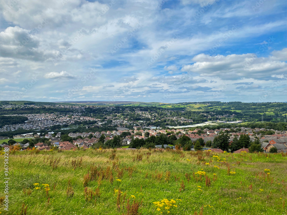 Panoramic view, over Shipley and Bradford, with grass, houses, and fields in the distance near, Bradford, UK