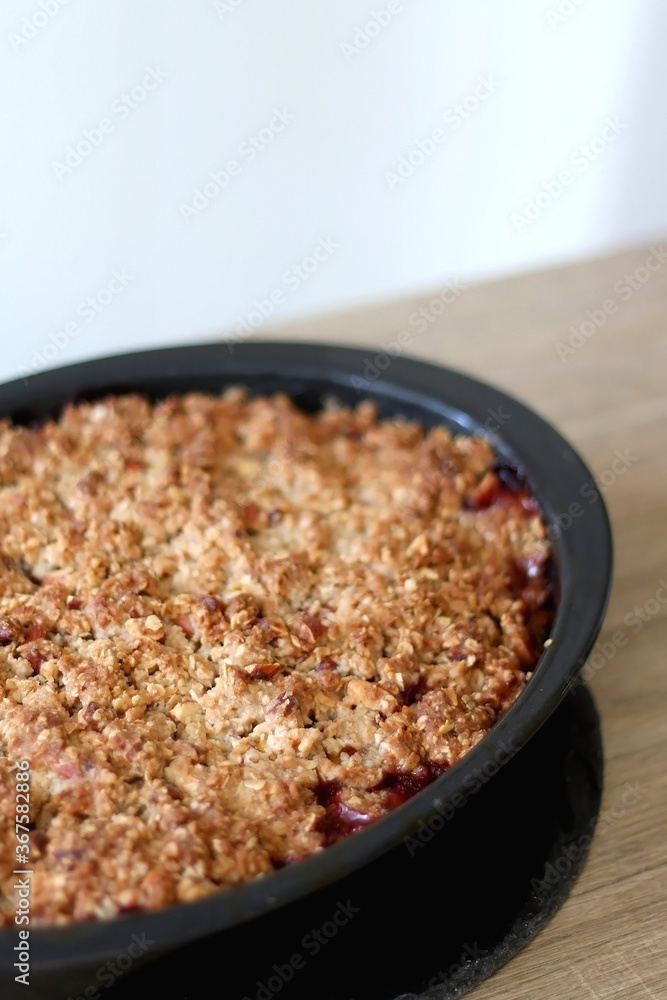 Homemade peach crumble served on a table. Selective focus. Homemade peach crumble served on a table. Selective focus.