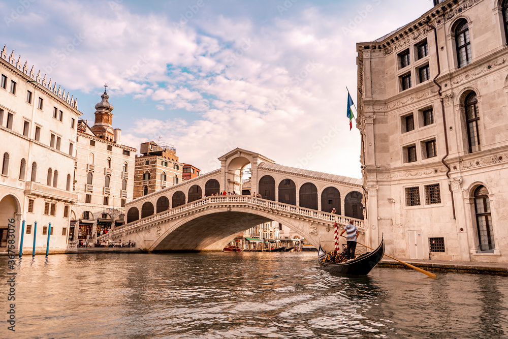 The beautiful Rialto bridge in the city of Venice in Italy seen from the boat.