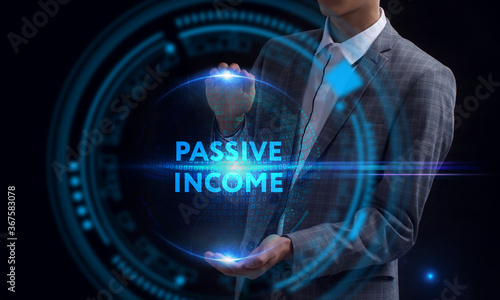 Business, Technology, Internet and network concept. Young businessman working on a virtual screen of the future and sees the inscription: Passive income