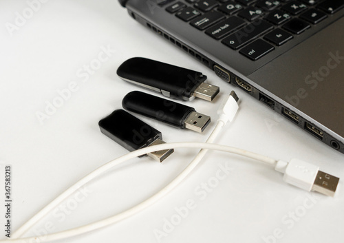 Flash drives and memory card readers arranged toghter. USB Micro cables. photo