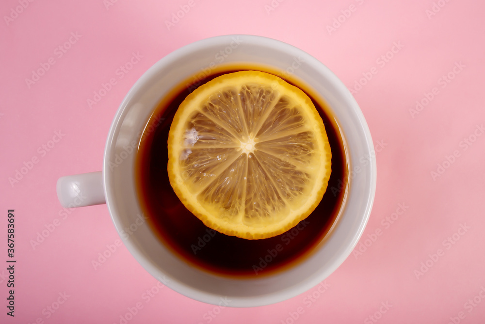 cup of tea with lemon on a pink background cup of tea with lemon on a pink background
