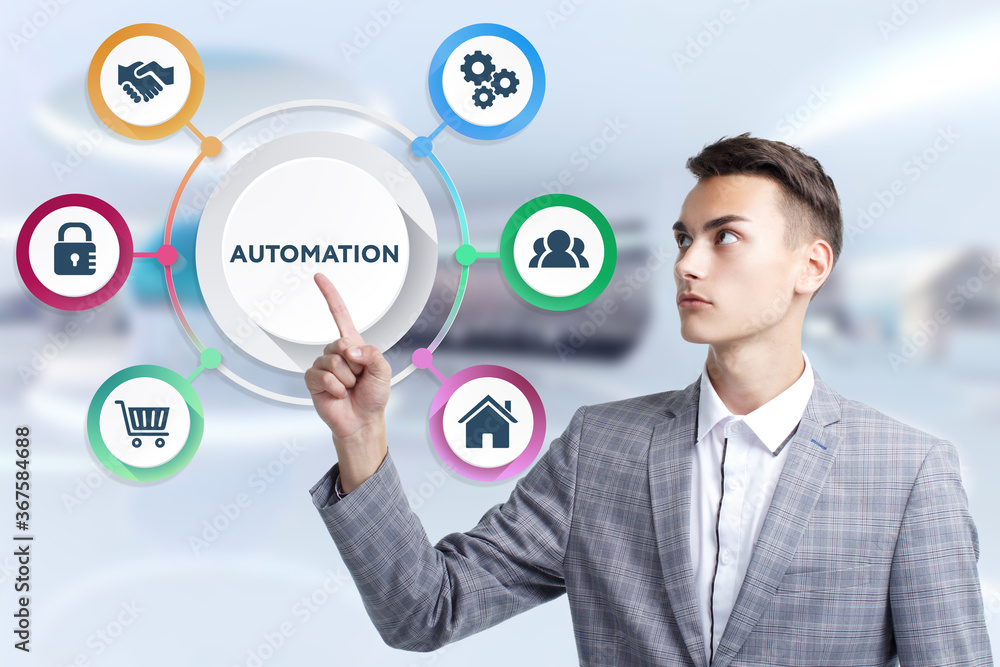 Business, Technology, Internet and network concept. Young businessman working on a virtual screen of the future and sees the inscription: Automation Business, Technology, Internet and network concept. Young businessman working on a virtual screen of the future and sees the inscription: Automation