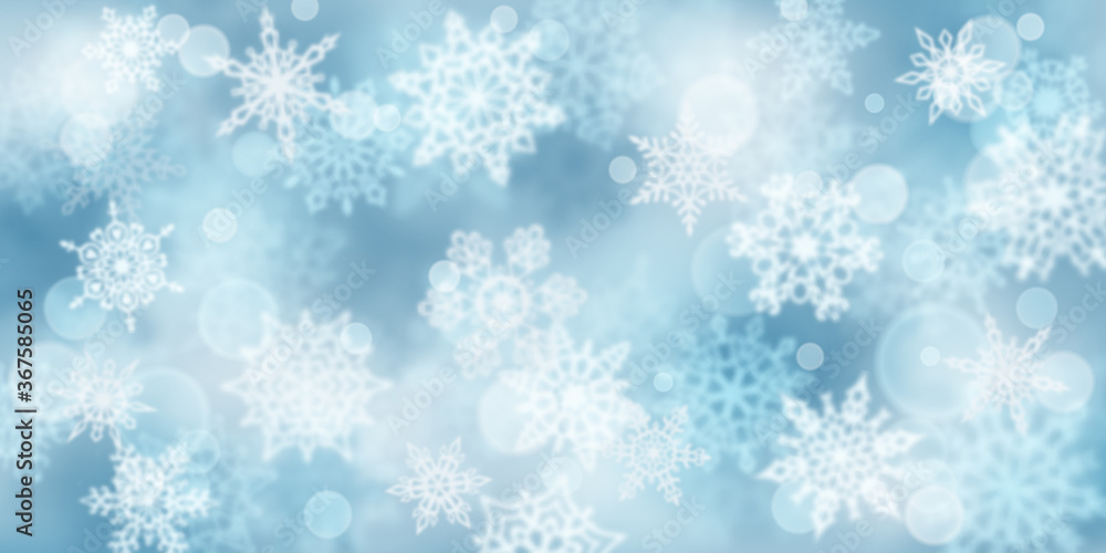 Christmas background of blurry snowflakes in light blue colors