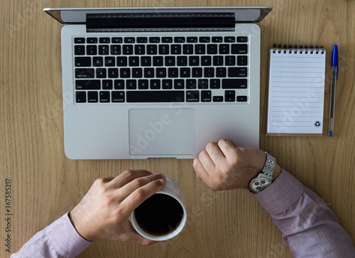 Young boy with a notebook and a cup of coffee