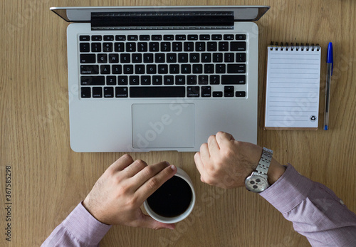 Young boy with a notebook and a cup of coffee