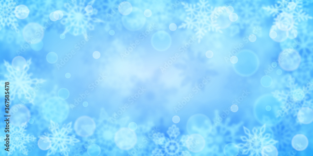 Christmas background of blurry snowflakes in light blue colors Christmas background of blurry snowflakes in light blue colors