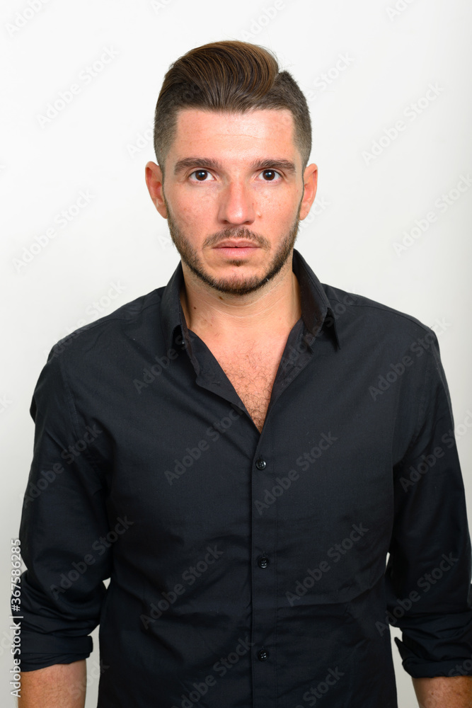 Studio shot of handsome bearded Hispanic businessman Studio shot of handsome bearded Hispanic businessman