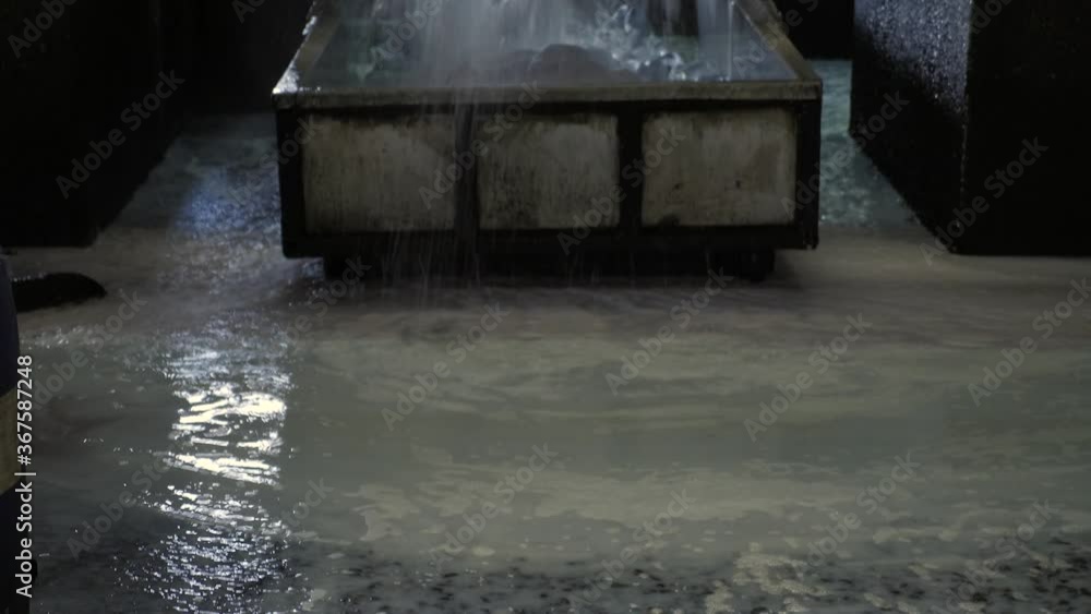 Unloading of a leather tanning vessel with water spill in tanning factory in Europe Unloading of a leather tanning vessel with water spill in tanning factory in Europe