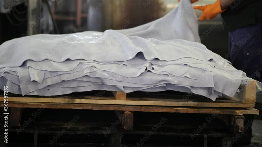 Wet leather on a wooden pallet after unloading tanning vessel