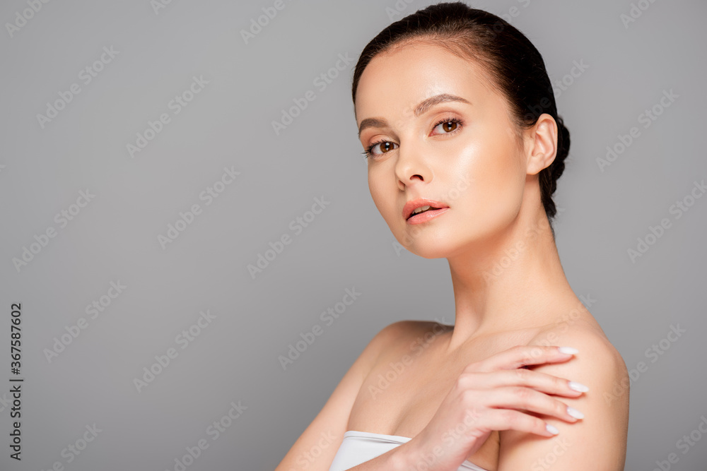 beautiful woman with perfect skin looking at camera isolated on grey beautiful woman with perfect skin looking at camera isolated on grey
