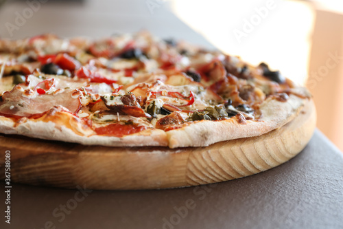 Delicious fresh pizza on table outdoors, closeup