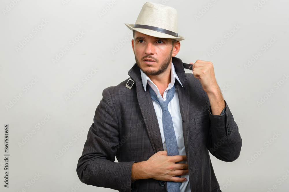 Portrait of handsome bearded Hispanic businessman wearing hat Portrait of handsome bearded Hispanic businessman wearing hat