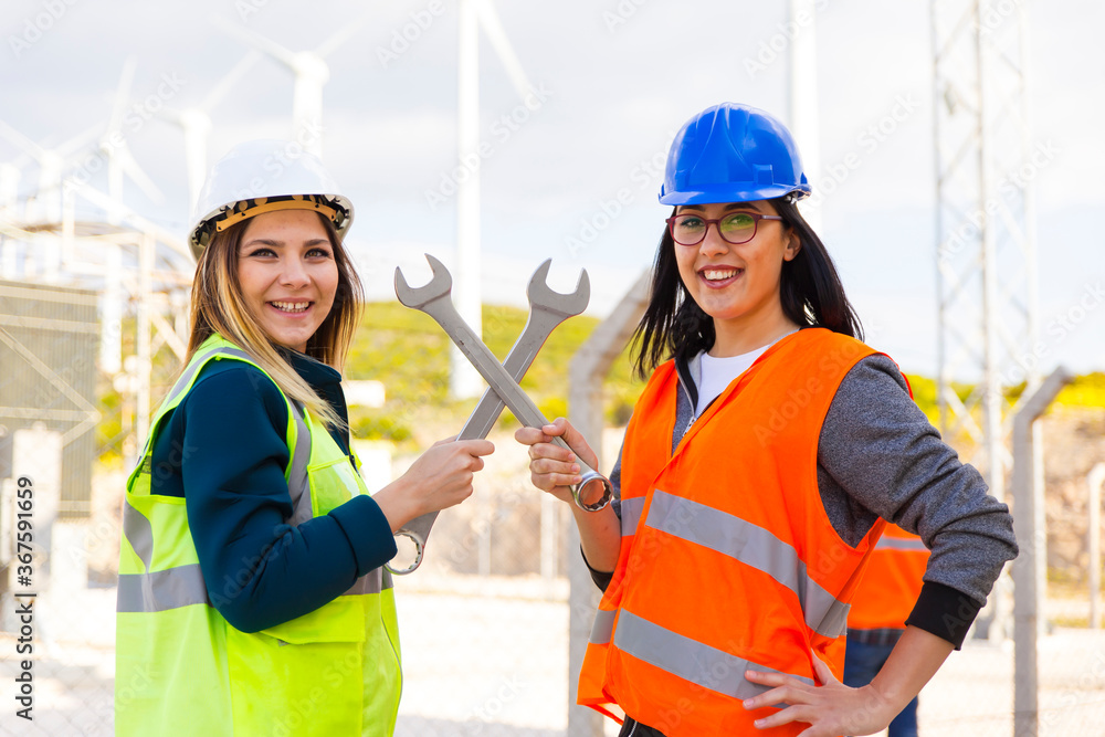 Portrait of strong and confident businesswomen working in electric power station