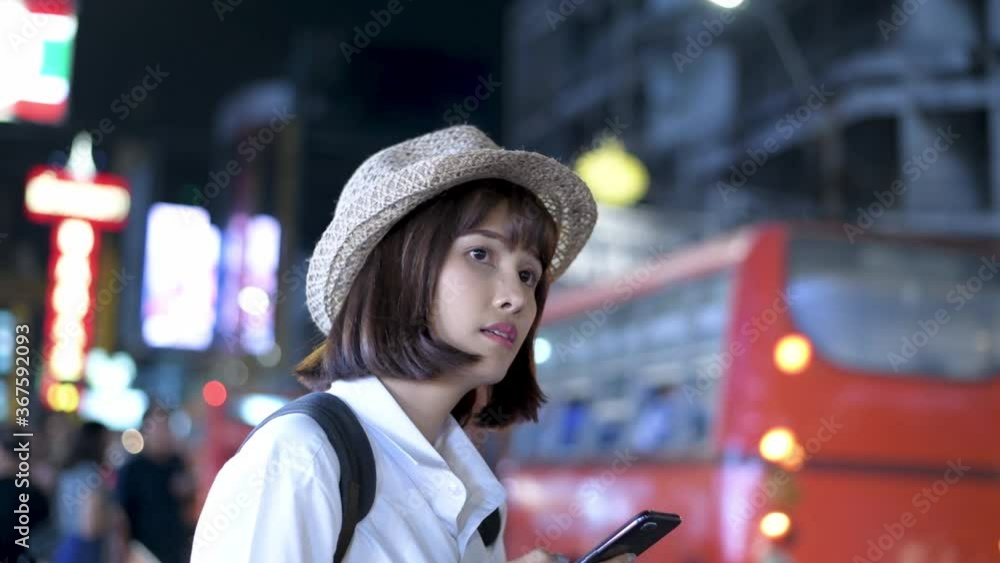 Tourism concept. Asian women playing mobile phones in the city. 4k Resolution. Tourism concept. Asian women playing mobile phones in the city. 4k Resolution.