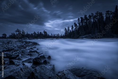A waterfall on a moonlit night in Northwest Ontario, Canada.