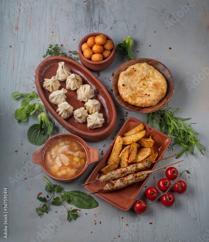food photography of set of traditional national georgian dinner dishes for children's menu, top view on gray textured background close up