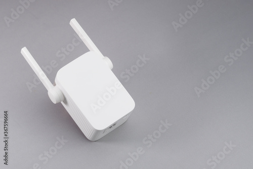 White Wireless WiFi repeater on gray background. photo