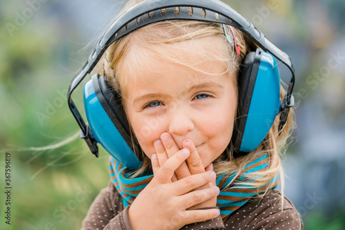 Happy toddler girl wearing earmuffs photo