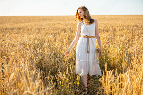 Happy young woman on field in summer day, Czech republic