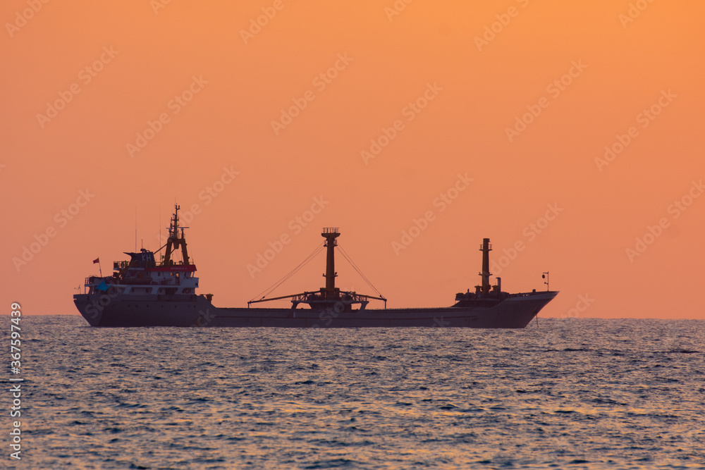 Freight ship on a sunset horizon