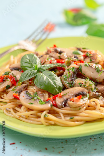 Pasta with mushrooms, sun-dried tomatoes and parsley.