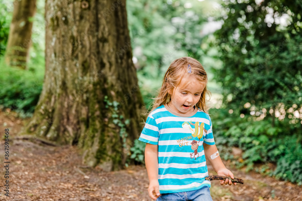 Girl with stick in forest Girl with stick in forest