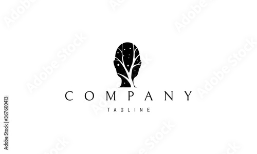 Vector logo on which an abstract image of a human head inside which is a silhouette of a tree.