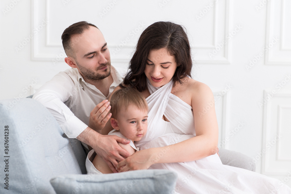 happy family in the living room married couple with small child and pregnant woman happy family in the living room married couple with small child and pregnant woman