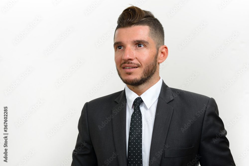 Portrait of handsome bearded Hispanic businessman in suit Portrait of handsome bearded Hispanic businessman in suit