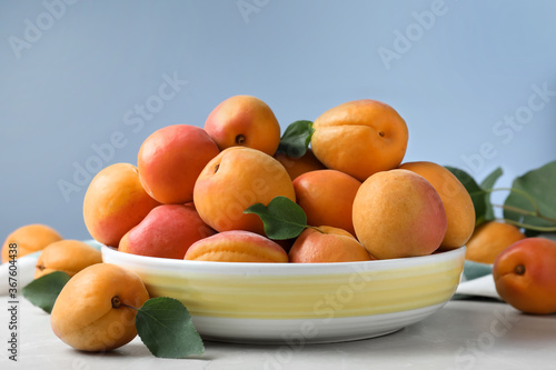 Fototapeta Naklejka Na Ścianę i Meble -  Delicious fresh ripe apricots on white table