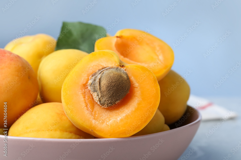 Delicious fresh ripe apricots on blue background, closeup