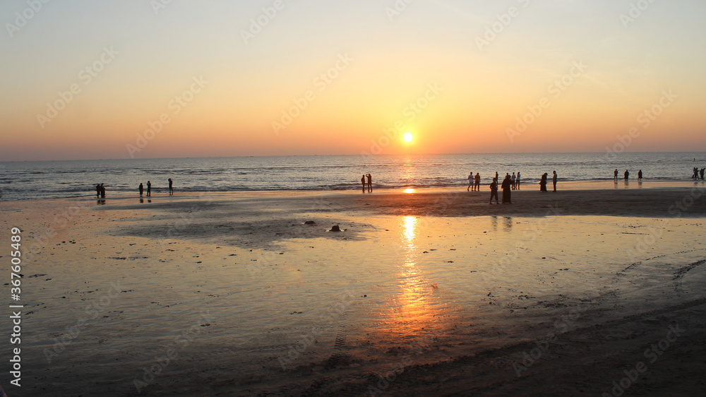 View of people enjoying sunset at the beach