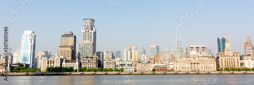 Shanghai, China - April 19, 2018: Panorama of the Bund (Waitan). The building with the lotus shaped rooftop is called Bund center. Popular waterfront promenade. photo