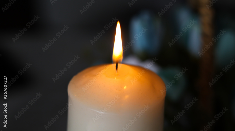 The candle is lit on a dark background.
