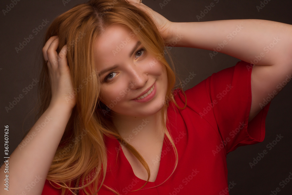 Studio portrait of an overweight young woman with light hair on a black background Studio portrait of an overweight young woman with light hair on a black background